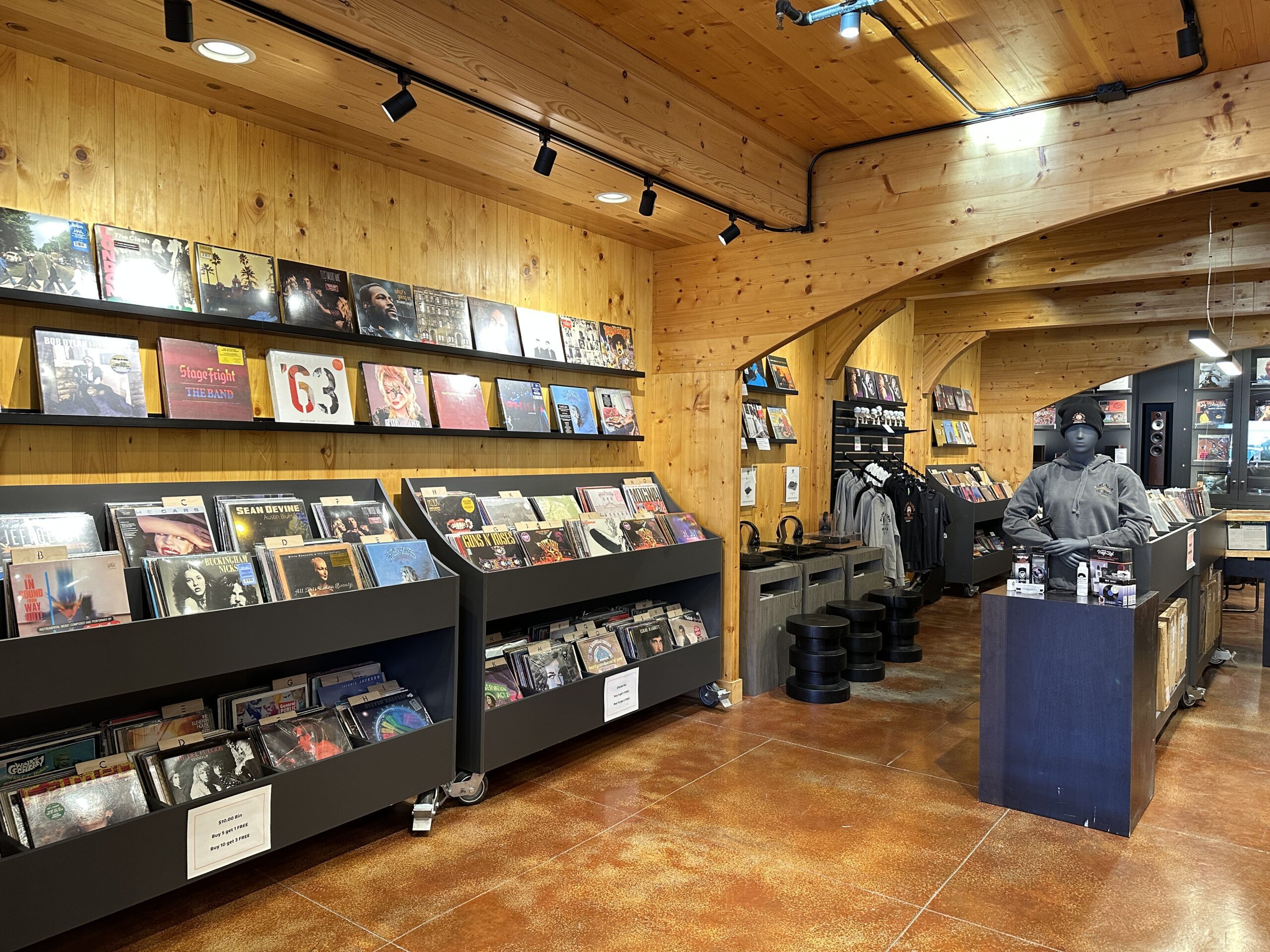 Shop interior with LPs, clothing, and a mannequin